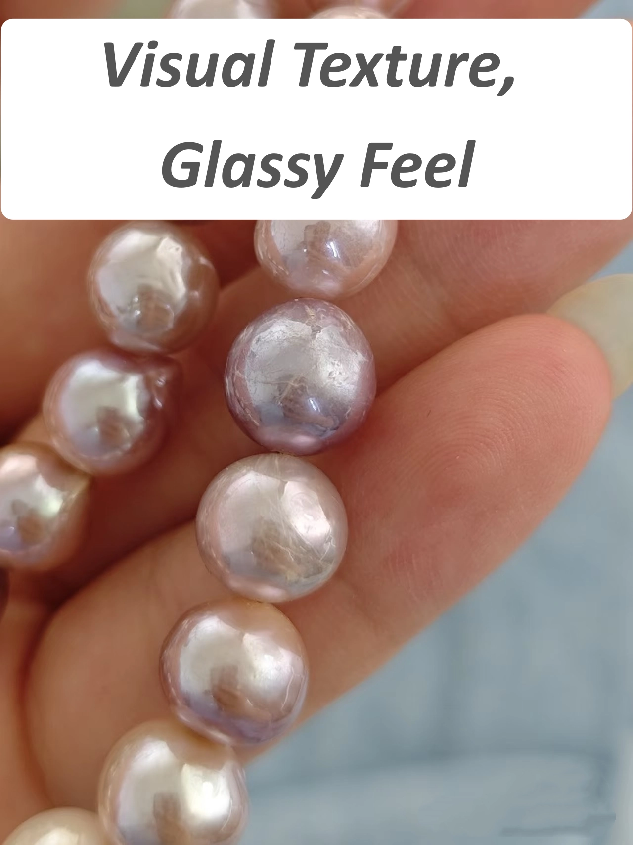 Thick coated pearl showing visible surface blemishes but feeling smooth
