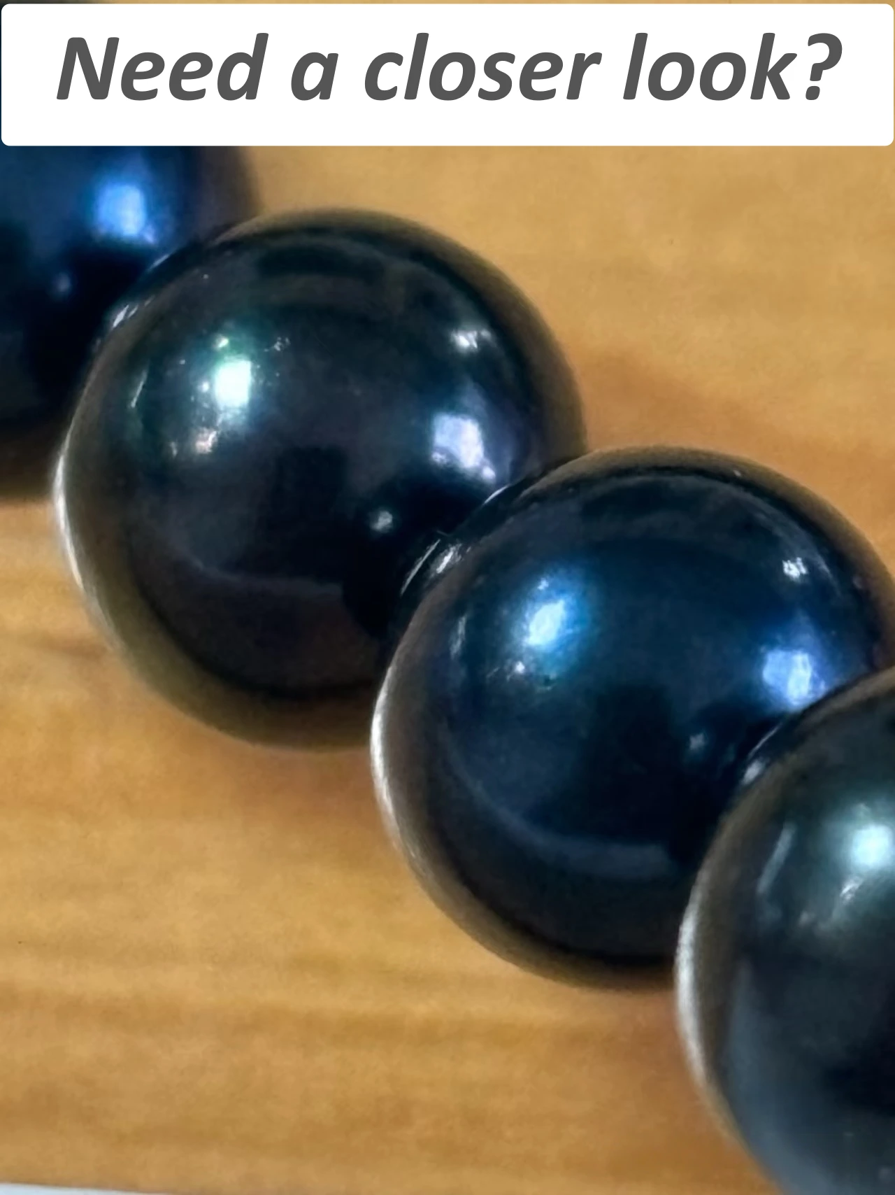 Close-up detail of a black pearl necklace for authenticity analysis