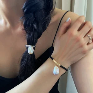 Gold and silver pearl hair ties, which could be worn also as bracelets, featuring genuine freshwater baroque pearl pendants.