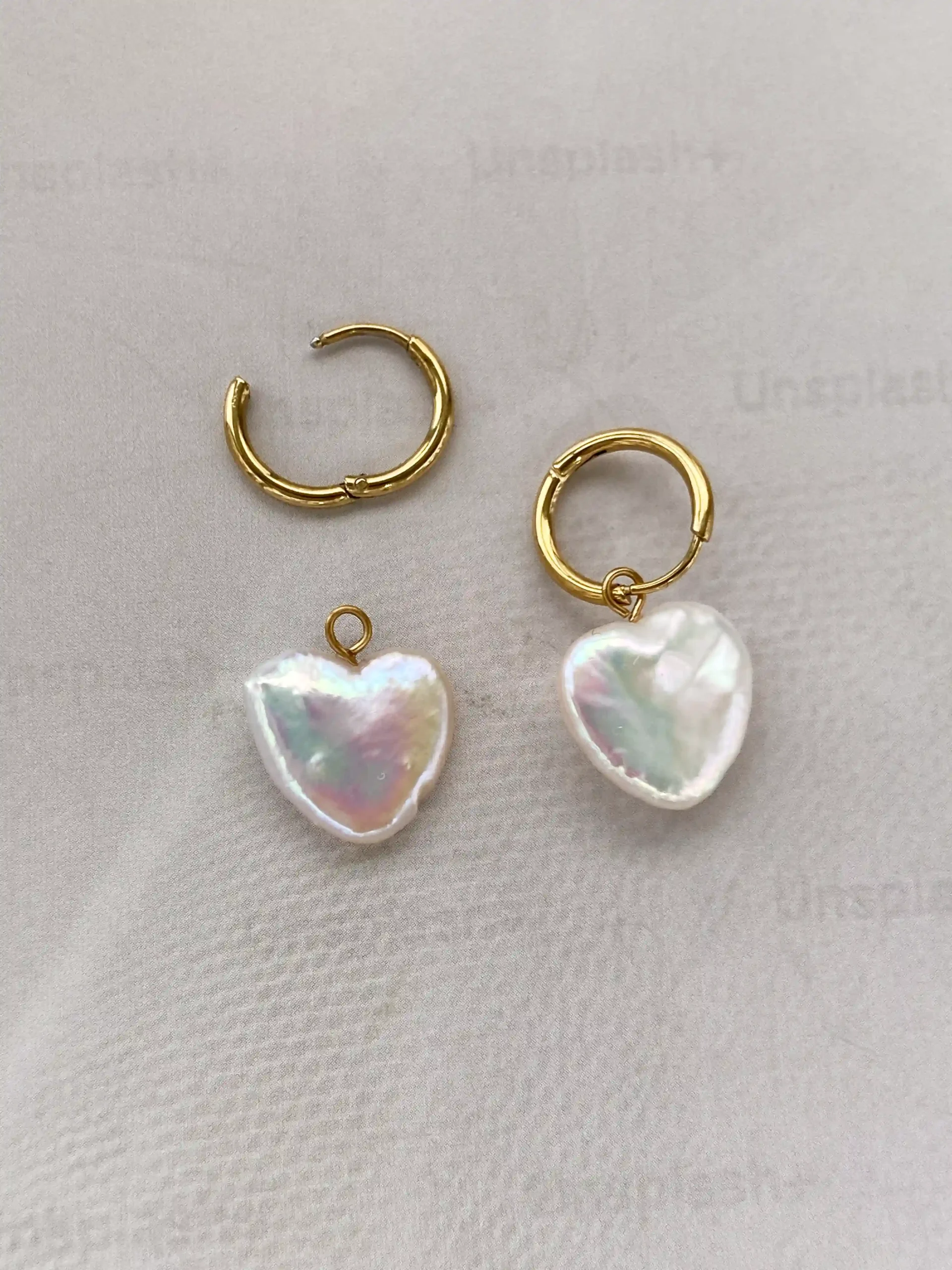 Gold natural heart-shaped pearl hoop earrings flat lay