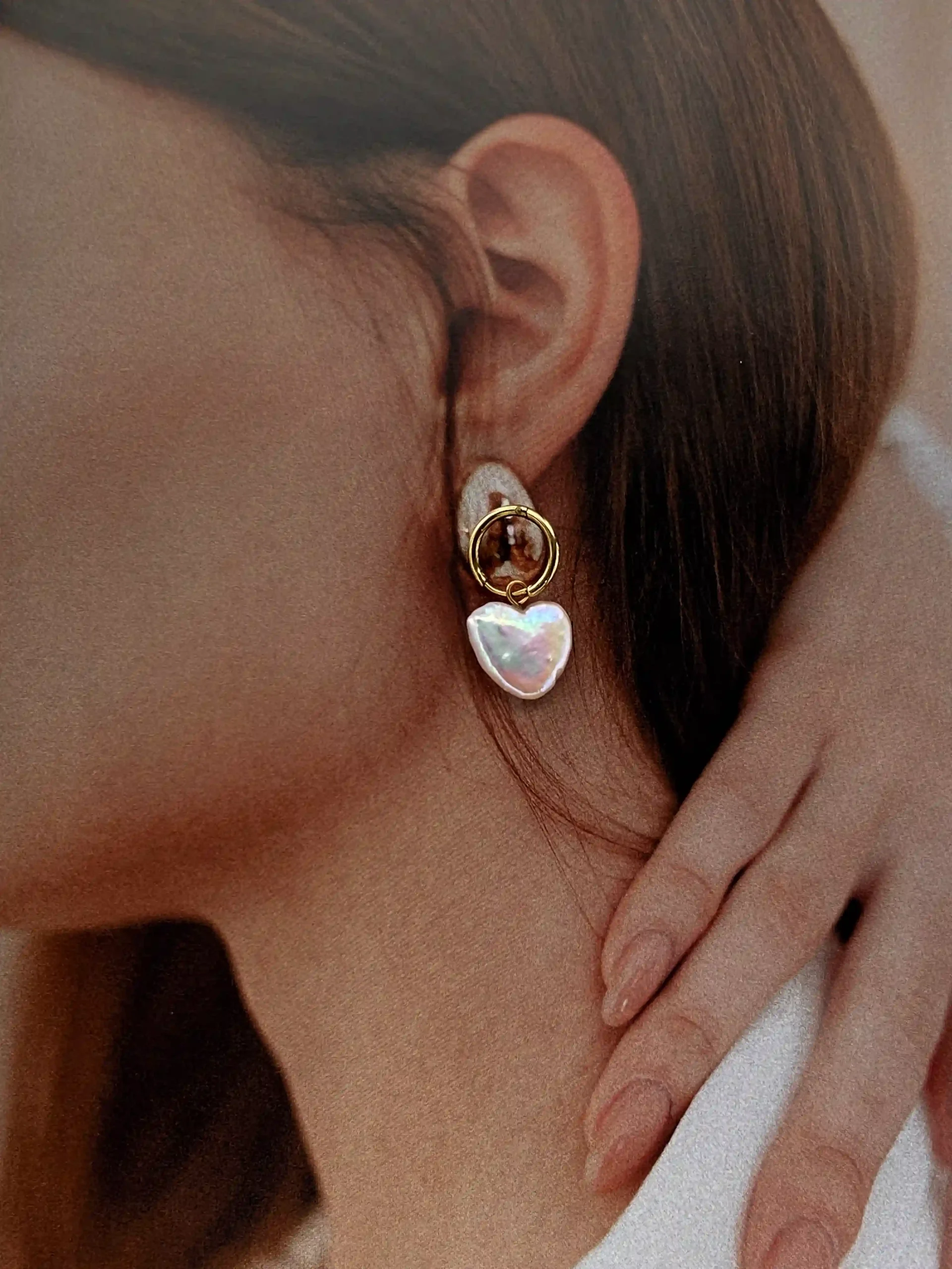 Gold natural heart-shaped pearl hoop earrings flat lay