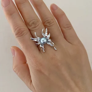 Natural blue Akoya pearl ring with sculptural sterling silver butterfly-inspired design worn on hand