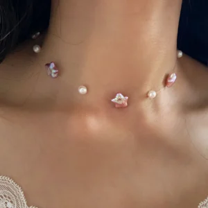 Woman wearing an invisible necklace with pink natural star pearls as a floating pearl choker